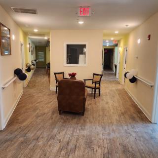 A cozy hallway with seating area, featuring chairs and a table.