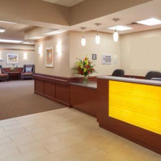 A well-lit office reception area with a modern design and comfortable seating.