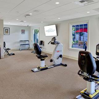 A modern gym with stationary bikes and exercise equipment.