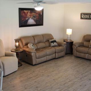 A cozy living room with comfortable seating and warm lighting.