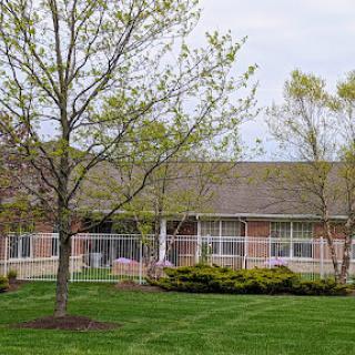 A peaceful residential building surrounded by greenery.