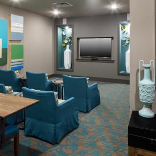A modern home theater room with comfortable seating and stylish decor.