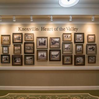 A wall display titled 'Knoxville: Heart of the Valley' featuring a collection of historical photographs.