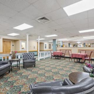 A spacious lobby with comfortable seating and patterned carpet.