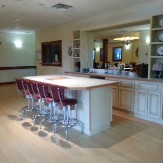 A spacious kitchen interior featuring a large island counter with bar stools.