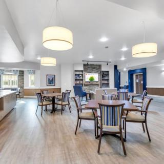 A modern and spacious dining area with stylish furniture and bright lighting.