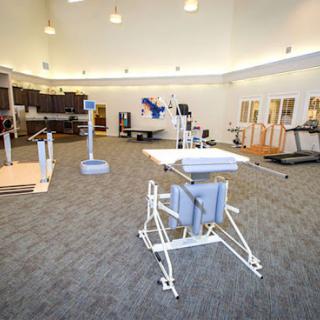 A spacious rehabilitation and fitness center equipped with various exercise machines.
