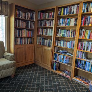 A cozy reading corner featuring bookshelves filled with various books.
