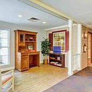 A home office space with wooden furniture and ample natural light.