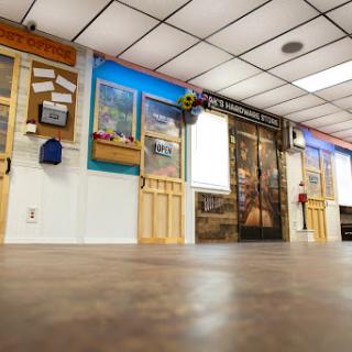 A view of an office interior showcasing colorful walls, wooden accents, and a spacious floor.