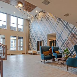 A modern lobby with stylish furnishings and large windows.