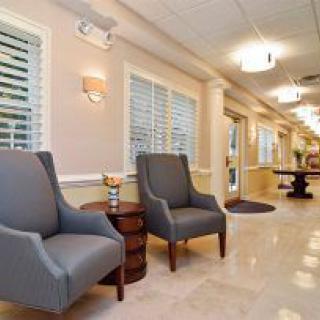 A cozy lobby area featuring two comfortable chairs and warm lighting.