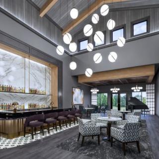 A modern lounge bar with elegant chandeliers and contemporary seating.