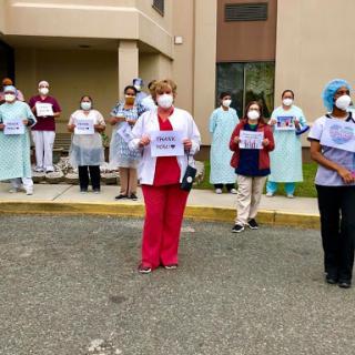 Healthcare workers advocating for their rights while demonstrating outside.