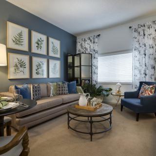 A beautifully decorated living room featuring a comfortable sofa, an armchair, and elegant wall art.