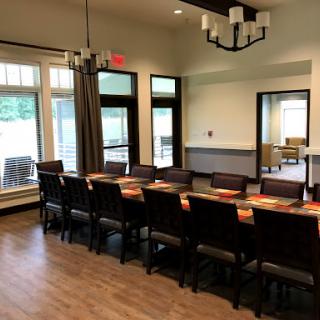 Spacious dining area with modern furnishings and ample natural light.