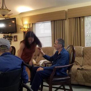 A group of people interacting in a cozy living room setting.