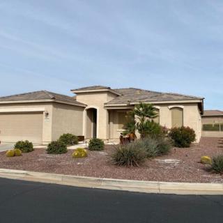A single-story suburban house with desert landscaping.