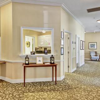 A warmly decorated hallway with various furnishings and lighting.
