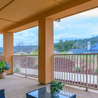 A spacious balcony with outdoor furniture and scenic landscape views.