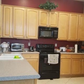 A well-organized kitchen featuring wooden cabinets and modern black appliances.