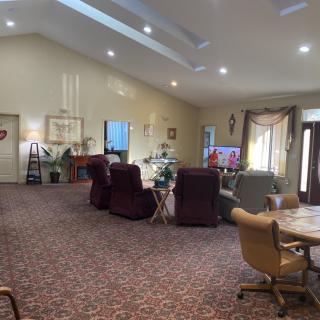 A spacious living room with recliner chairs and a television.