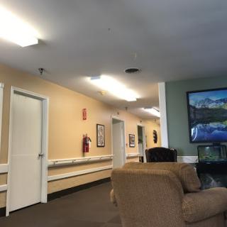 A quiet lobby area with seating and a view of the hallway.