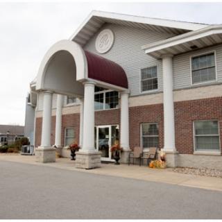 A modern building featuring a welcoming entrance with columns and an awning.