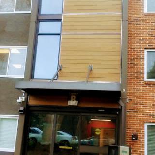 A modern building entrance with a mix of materials.