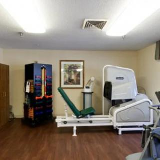 A fitness room equipped with various exercise machines and equipment.