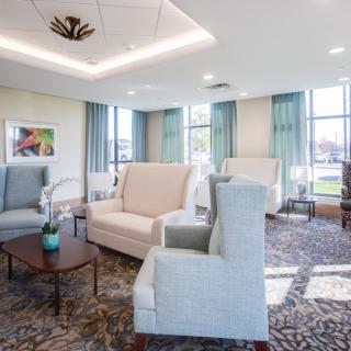 A cozy and well-lit living room featuring comfortable seating and elegant decor.