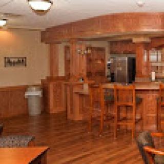 A well-designed recreational kitchen and bar area featuring wooden elements and a modern aesthetic.