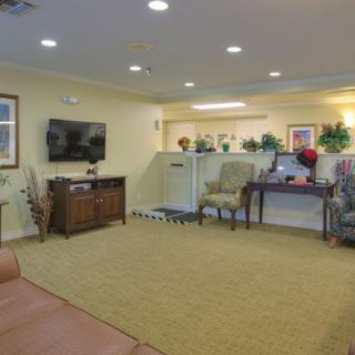 A cozy living room with elegant decor and a television on the wall.