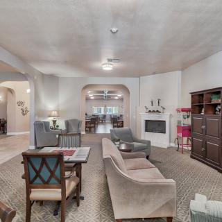 A spacious living room with a cozy seating area and a fireplace.