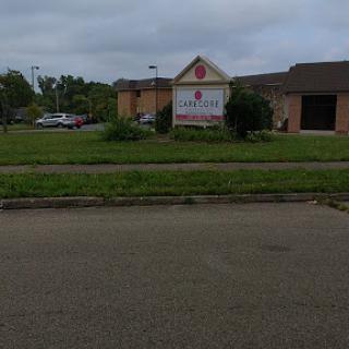 A view of a building with signage in an outdoor setting under a cloudy sky.