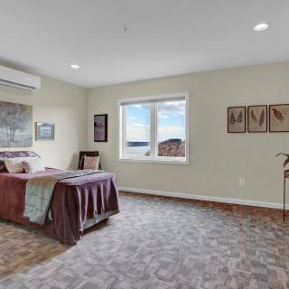 A modern and comfortable bedroom with neutral colors and tasteful decor.
