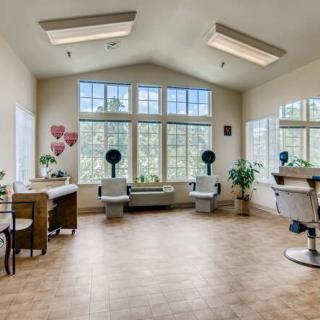 A bright and spacious hair salon with large windows, offering plenty of natural light.
