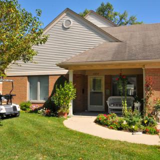 A single-story house with a neatly maintained garden and a covered porch.
