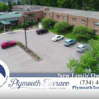 Aerial view of Plymouth Terrace, showcasing the parking lot and surrounding greenery, now under new family ownership.