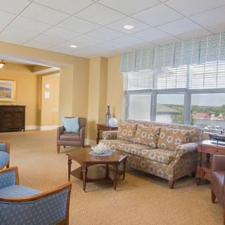 A cozy living room with comfortable seating and large windows providing natural light.