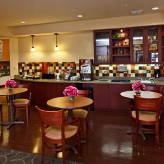 A cozy cafe interior with seating and a decorative counter area.