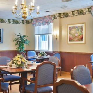 A well-decorated dining room with elegant furniture and a chandelier.