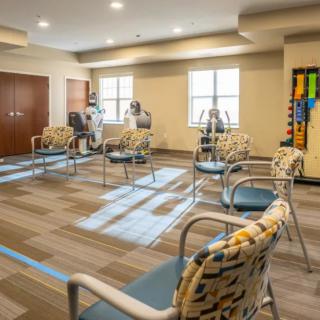 A modern waiting room with arranged seating and ample lighting.