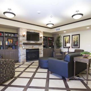 A modern living room with a fireplace, television, and comfortable seating area.