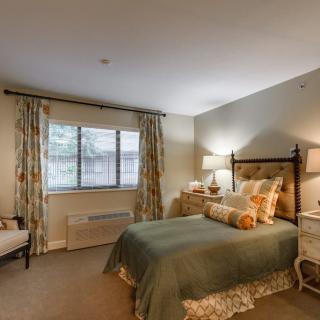 A cozy and elegantly decorated bedroom with soft lighting.