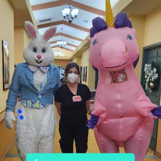 A cheerful encounter in the hallway with a bunny and a unicorn costume character.