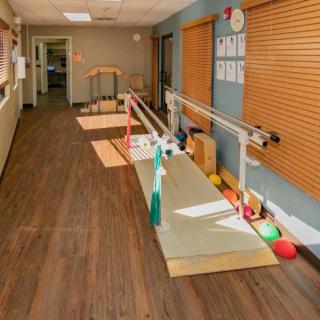 A rehabilitation room equipped with parallel bars for physical therapy exercises.