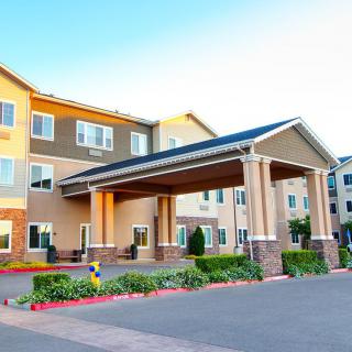A modern hotel with a welcoming entrance and well-maintained landscaping.