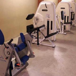 A row of exercise machines in a gym setting.