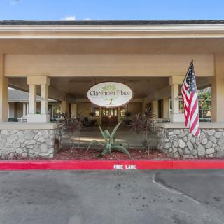 The entrance to a building with a sign and an American flag displayed.